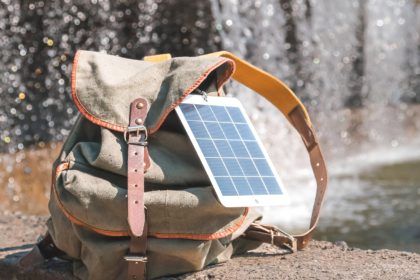Portable solar panel.Traveler uses green energy to charge gadgets.Eco crisis,eo friendly,sustainable