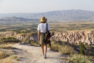 Woman walking to viewpoint near Uchisar, Cappadocia, Turkey