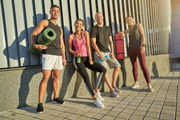 Young multiracial people holding sport equipment