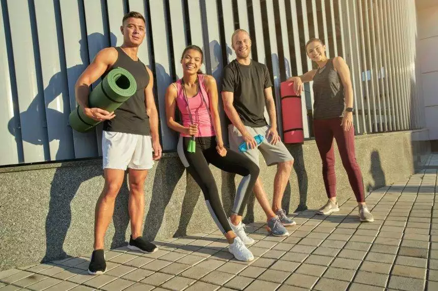 Young multiracial people holding sport equipment